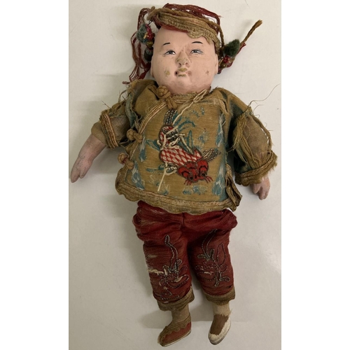 742 - An early 1900's Chinese opera doll, with composite face, bisque feet & original clothing. 21cm tall.