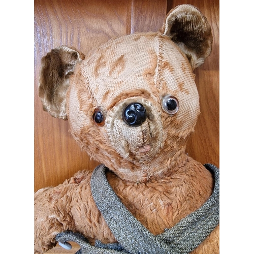 763 - A mid-century teddy bear, in dungarees (likely added later). Height 35cm.