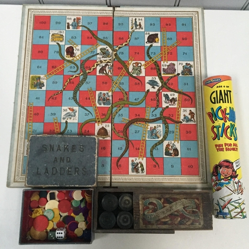 777 - Three vintage games. To include an early snakes & ladders game board, with box of counters, a boxed ... 