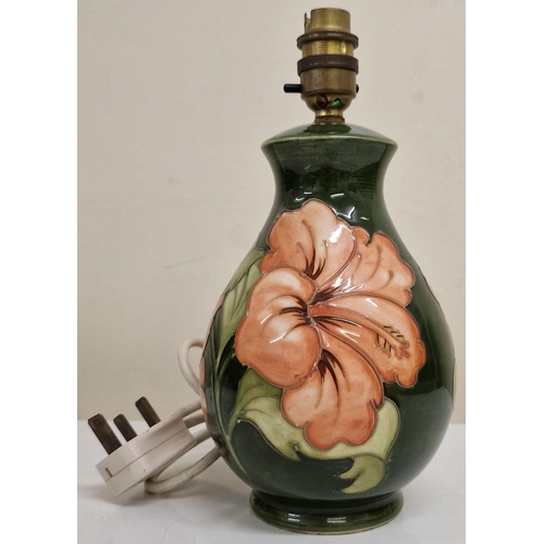 A Moorcroft Hibiscus pattern table lamp, without shade. PAT test pass & functionality test indicates in working order. Height 26cm, diameter 12.5cm.