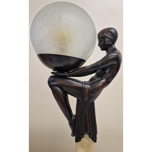 5044 - An art-deco lamp, in the manner of Max Le Verrier, featuring a seated female figure in a seated posi... 