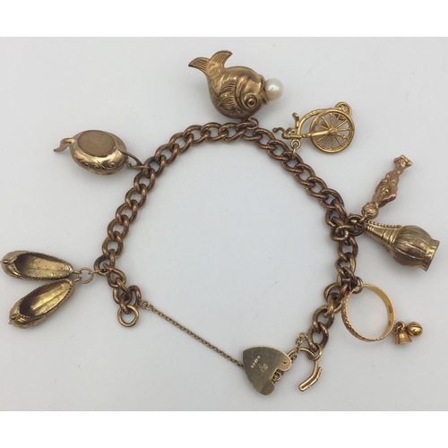 A hallmarked 9ct gold bracelet & seven charms. Weight approx. 32.5g