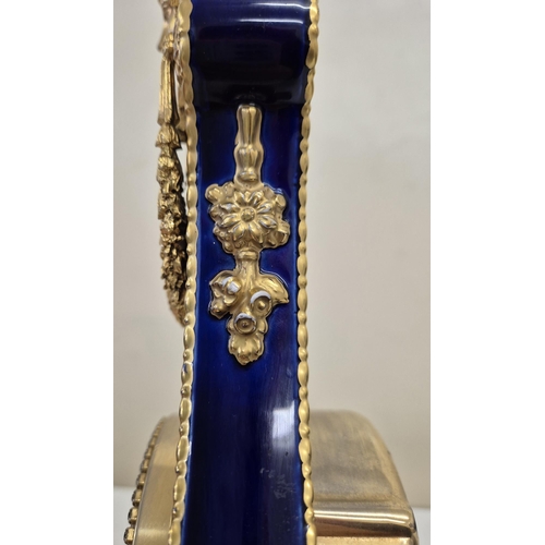 5057 - A reproduction Marie Antoinette clock (original held in V&A Museum). Blue glazed porcelain with gilt... 