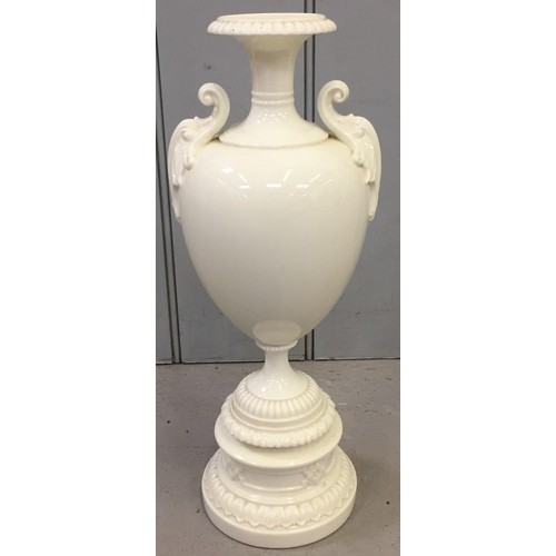 5136 - A Royal Worcester, cream porcelain, twin-handled pedestal vase, marked 1969, together with a similar... 