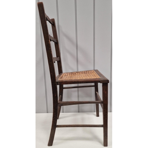 6107 - An Edwardian ladder back chair, with woven cane seat. Dimensions(cm) H83(42 to seat), W39, D35.