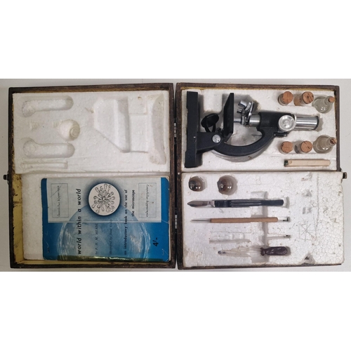 5011 - A vintage, cased student microscope & accessories, by 'Britex'.