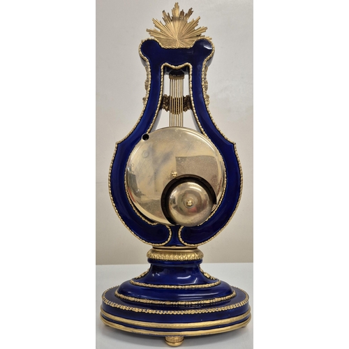 5057 - A reproduction Marie Antoinette clock (original held in V&A Museum). Blue glazed porcelain with gilt... 