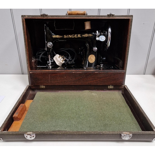 5063 - A 1944 Singer sewing machine, with case. Dates to 1944, with Singer electrification unit. Will requi... 