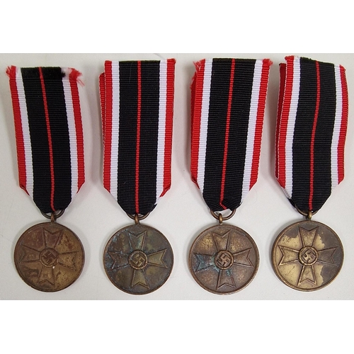 A collection of four WWII German War Merit medals.