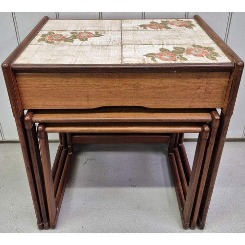 4872 - A mid-century teak nest of three tables. The larger featuring a tiled top & single drawer. Largest d... 