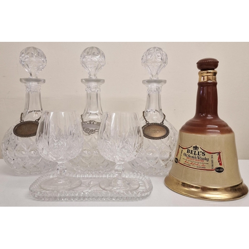 5854 - A mixed lot of drinkware. To include a set of three decanters, with silver-plated labels, a Bell's W... 