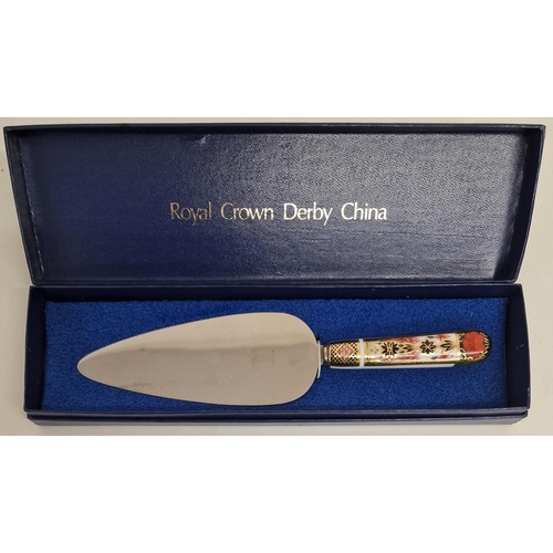 5881 - A boxed Royal Crown Derby cake slice, together with a King George VI souvenir coronation spoon.