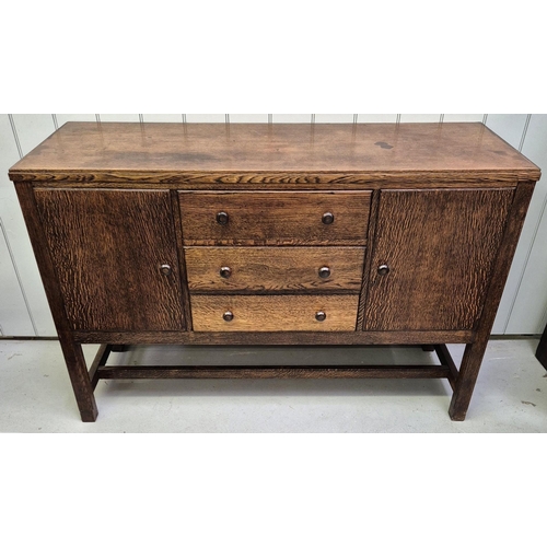 6331 - A 1950's walnut sideboard. Double cupboard aside triple drawers, raised on stretchered legs.
Dimensi... 