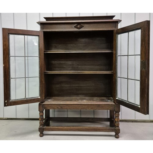 4855 - A vintage, walnut glazed bookcase, raised on stretchered legs. Key present. Dimensions(cm) H119, W77... 