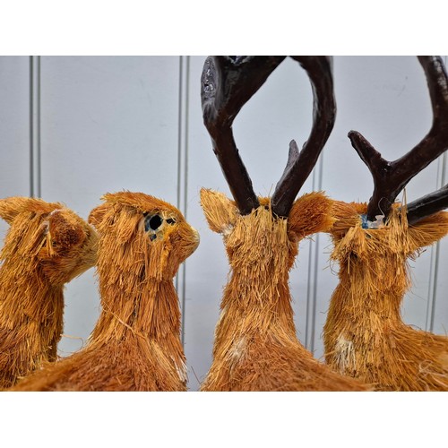 5897 - A collection of 8 Christmas reindeers. To include 2 ceramic, 2 stuffed & 4 straw. Tallest 40cm.