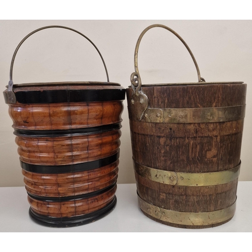 4807 - A duo of vintage Peat Buckets, with brass inners. To include a brass-bound oak example & an ebonised... 