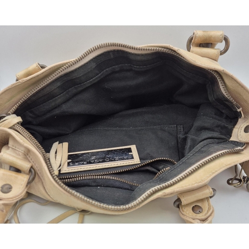 4885 - An original 'Balenciaga' motorcycle handbag, in cream leather.