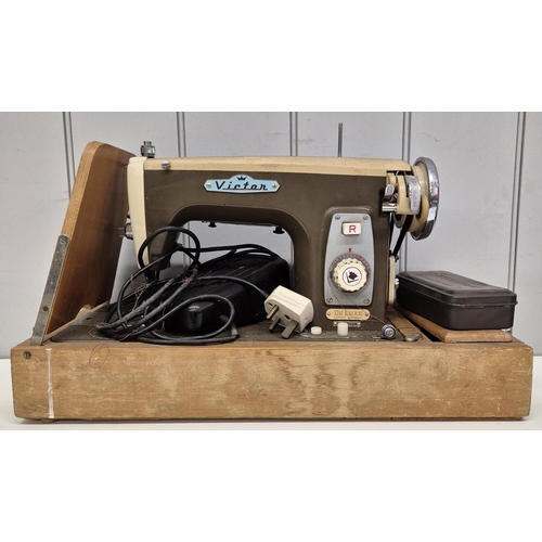 4825 - A vintage 'Victor' electric sewing machine, with Hillman motor, together with various dressmaking pa... 