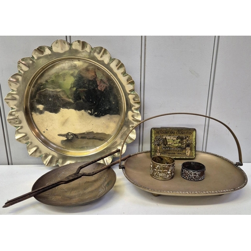 4828 - A collection of 7 pieces of useful & decorative metalware. To include brass charger, napkin rings, '... 