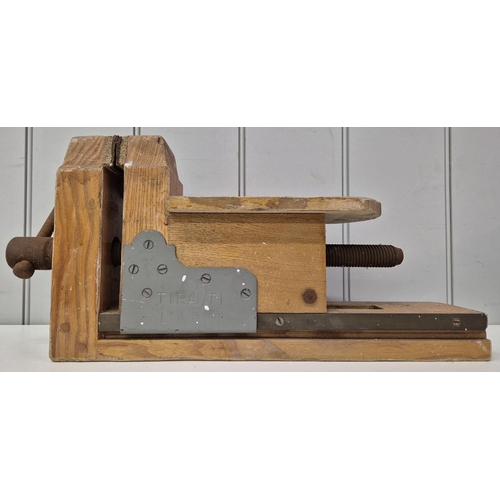 4965 - A wooden bench vice, by 'Tiranti', London. Dimensions(cm) H23, W48, D20.