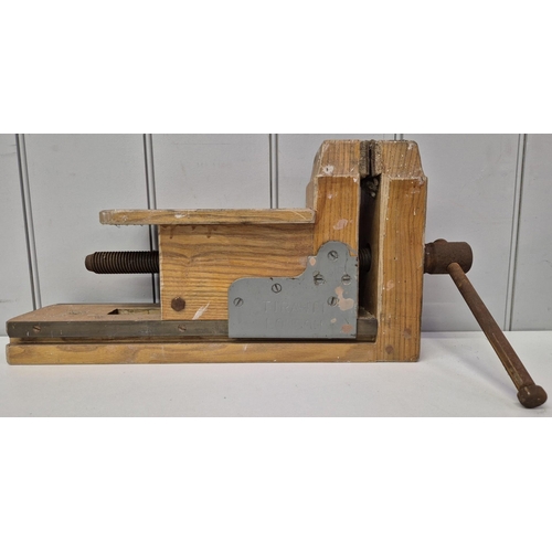 4965 - A wooden bench vice, by 'Tiranti', London. Dimensions(cm) H23, W48, D20.