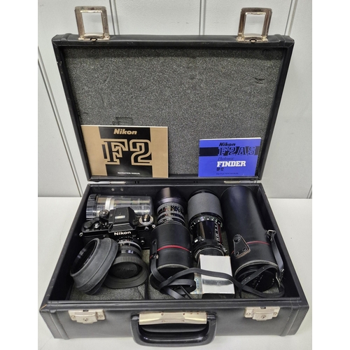 5975 - A professional Nikon F2 35mm SLR camera, with a huge range of accessories, to include six lenses, fl... 