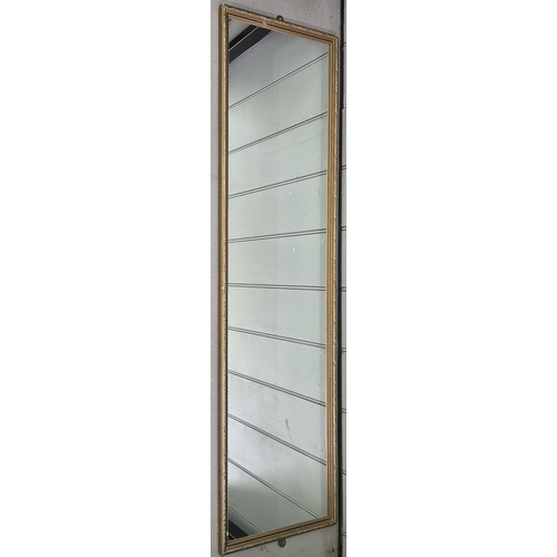 6305 - A retro wall mirror. Dimensions 129cm x 33cm.