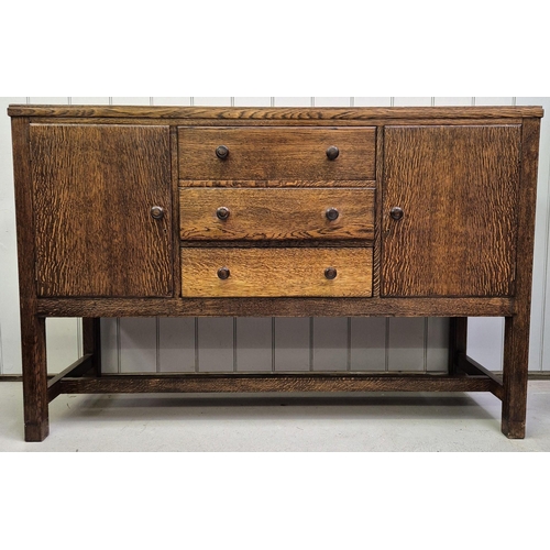 6331 - A 1950's walnut sideboard. Double cupboard aside triple drawers, raised on stretchered legs.
Dimensi... 