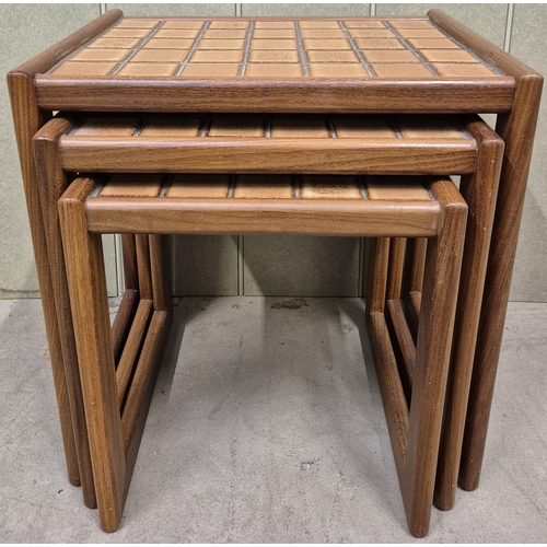 13 - A mid-century nest of three tiled tables. Largest dimensions(cm) H49, W47, D36.