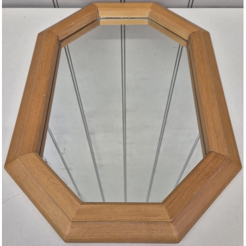 69 - A beech framed, contemporary octagonal mirror, together with a framed comedy print. Respective dimen... 