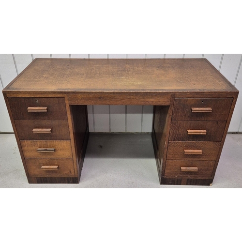 98 - A c.1940's oak kneehole pedestal desk. Eight drawers. No key present. Dimensions(cm) H78, W137, D62.