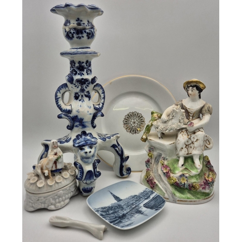 110 - A mixed lot of vintage ceramic pieces. To include an elaborate Delft candlestick, Limoges plate, etc... 