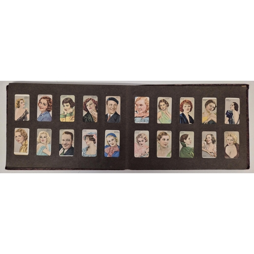 154 - A cigarette card album full of Gallaher Ltd & Godfrey Phillips Famous Faces/Scenes From Films sets.