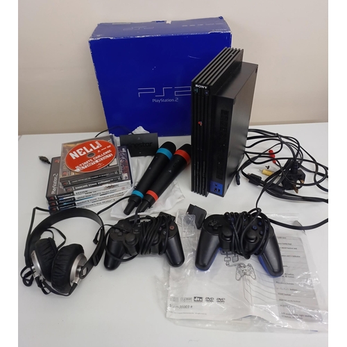 170 - A Playstation 2 with box, PS1/2 games and accessories, Singstar microphones and a pair of headphones... 