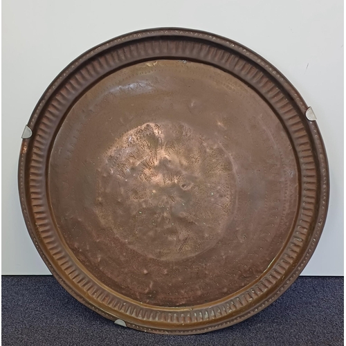 198 - A large copper Persian charger. Diameter 58cm.