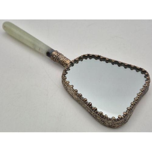 64 - A vintage Chinese Hand Mirror. Enamelled revers with white metal surround & Jade handle.  Length 14c... 