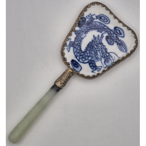 64 - A vintage Chinese Hand Mirror. Enamelled revers with white metal surround & Jade handle.  Length 14c... 