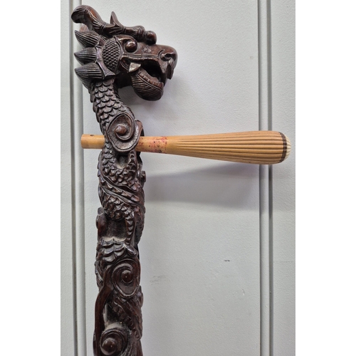 83 - A vintage Dragon head Chinese erhu, with bow. Missing strings & one tuning peg. Length 78cm.