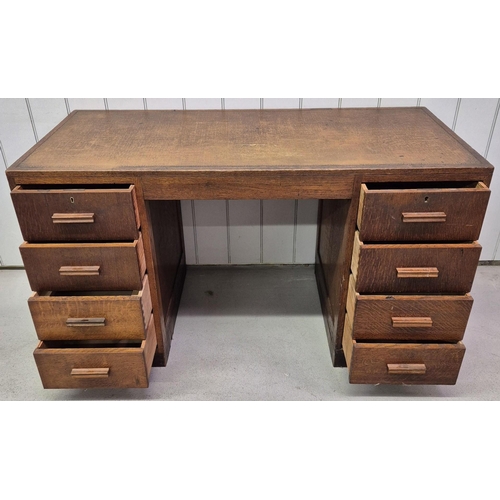 98 - A c.1940's oak kneehole pedestal desk. Eight drawers. No key present. Dimensions(cm) H78, W137, D62.