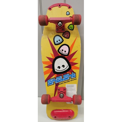 4262 - A colourful 1980's skateboard, by 'Skaight Board Stupid'. Length 77cm, width 26cm.