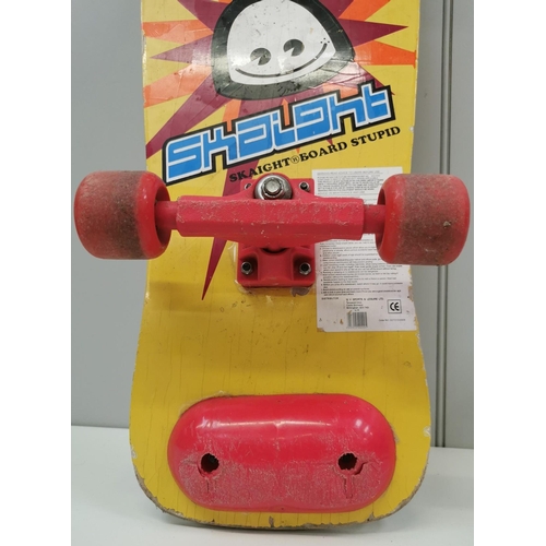 4262 - A colourful 1980's skateboard, by 'Skaight Board Stupid'. Length 77cm, width 26cm.