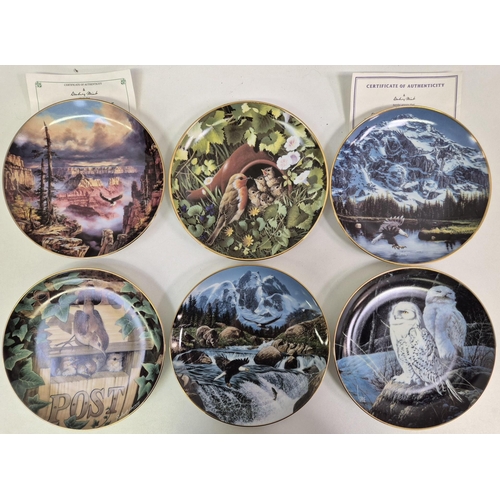 675 - A collection of 12 Danbury Mint wildlife-themed collector's display plates.