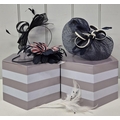 A selection of three fascinators, feathers & a pair of hat boxes.