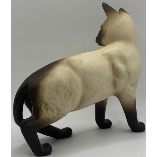 701 - Beswick Siamese cat figure, together with a cast Dachshund figure. Respective lengths 17cm, 16cm.
