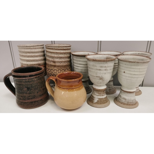 677 - A mixed lot of nine pieces of studio pottery. To include a set of five goblets, a 'Weston Cider Mill... 