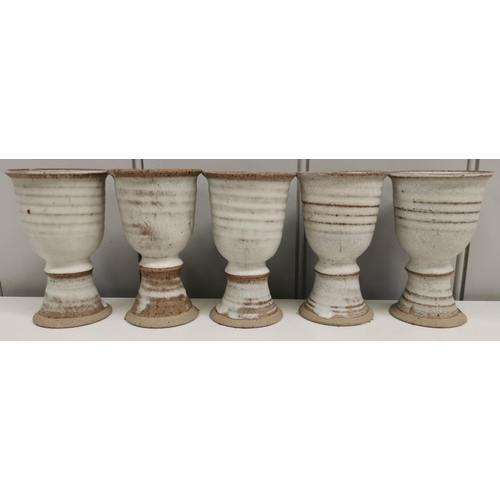 677 - A mixed lot of nine pieces of studio pottery. To include a set of five goblets, a 'Weston Cider Mill... 