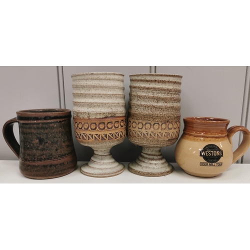 677 - A mixed lot of nine pieces of studio pottery. To include a set of five goblets, a 'Weston Cider Mill... 