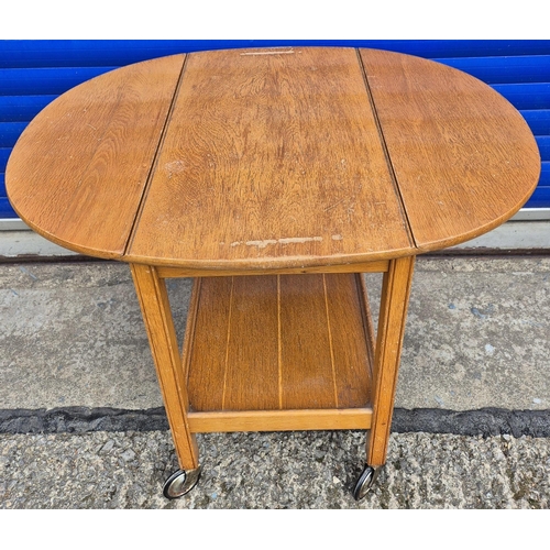537 - Two tea trolley tables. To include a rectangular pine example with removable tray & another extendin... 