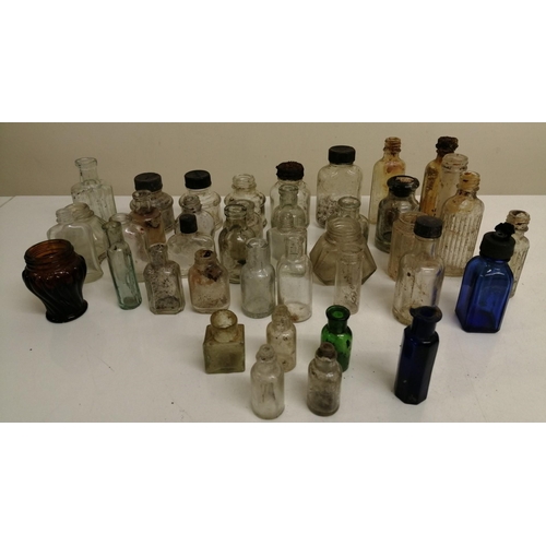 657 - A collection of forty miniature glass bottles. Mostly unbranded, but others include 'Stephens' & 'Ta... 