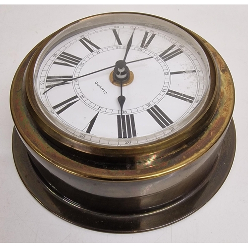 687 - A miniature battery-operated longcase clock, together with a brass port-hole clock. A/F condition.
R... 